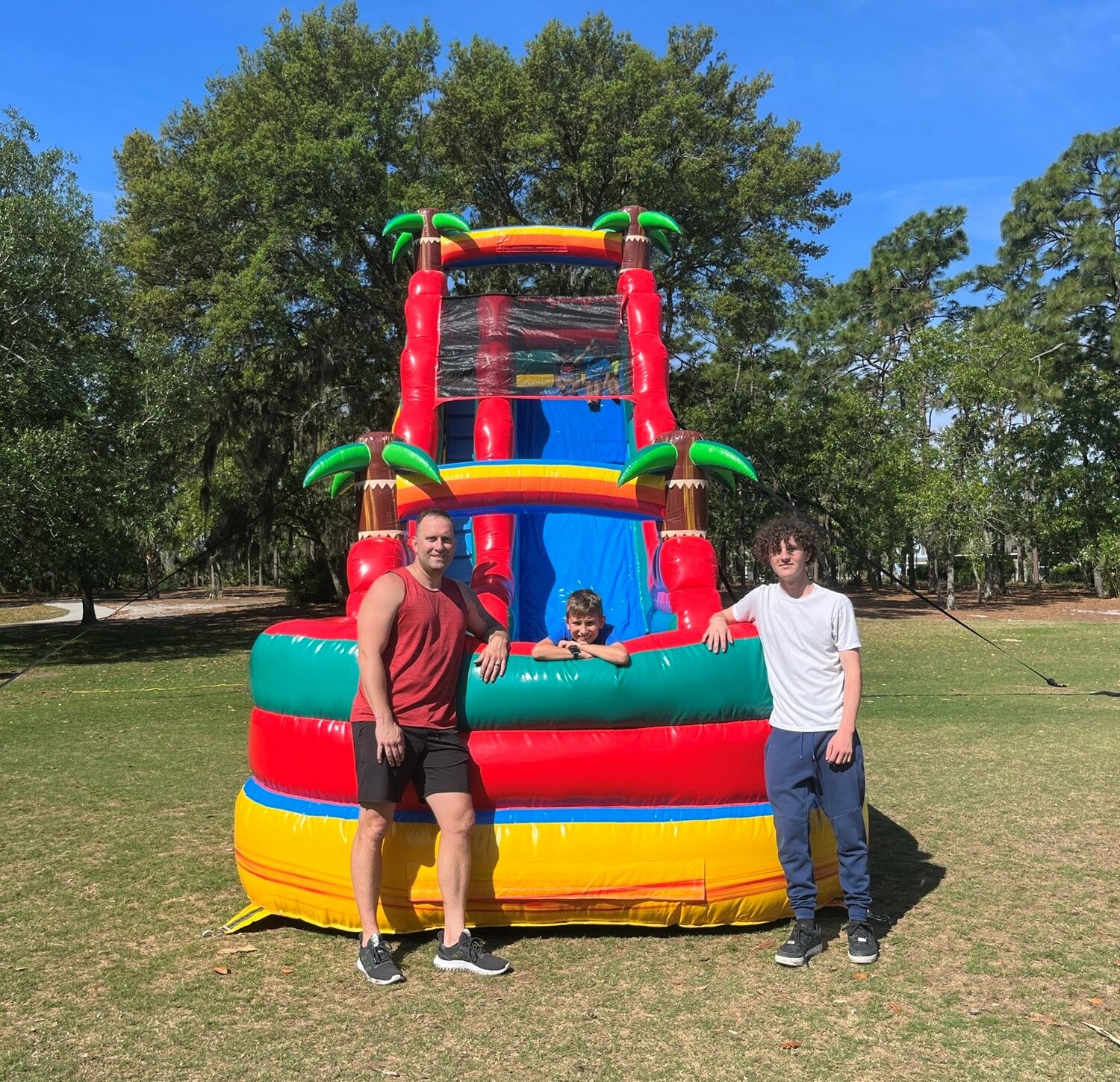 Adam White, Eli White and Rogan Drainer are seen with their 21-foot “volcano” slide.